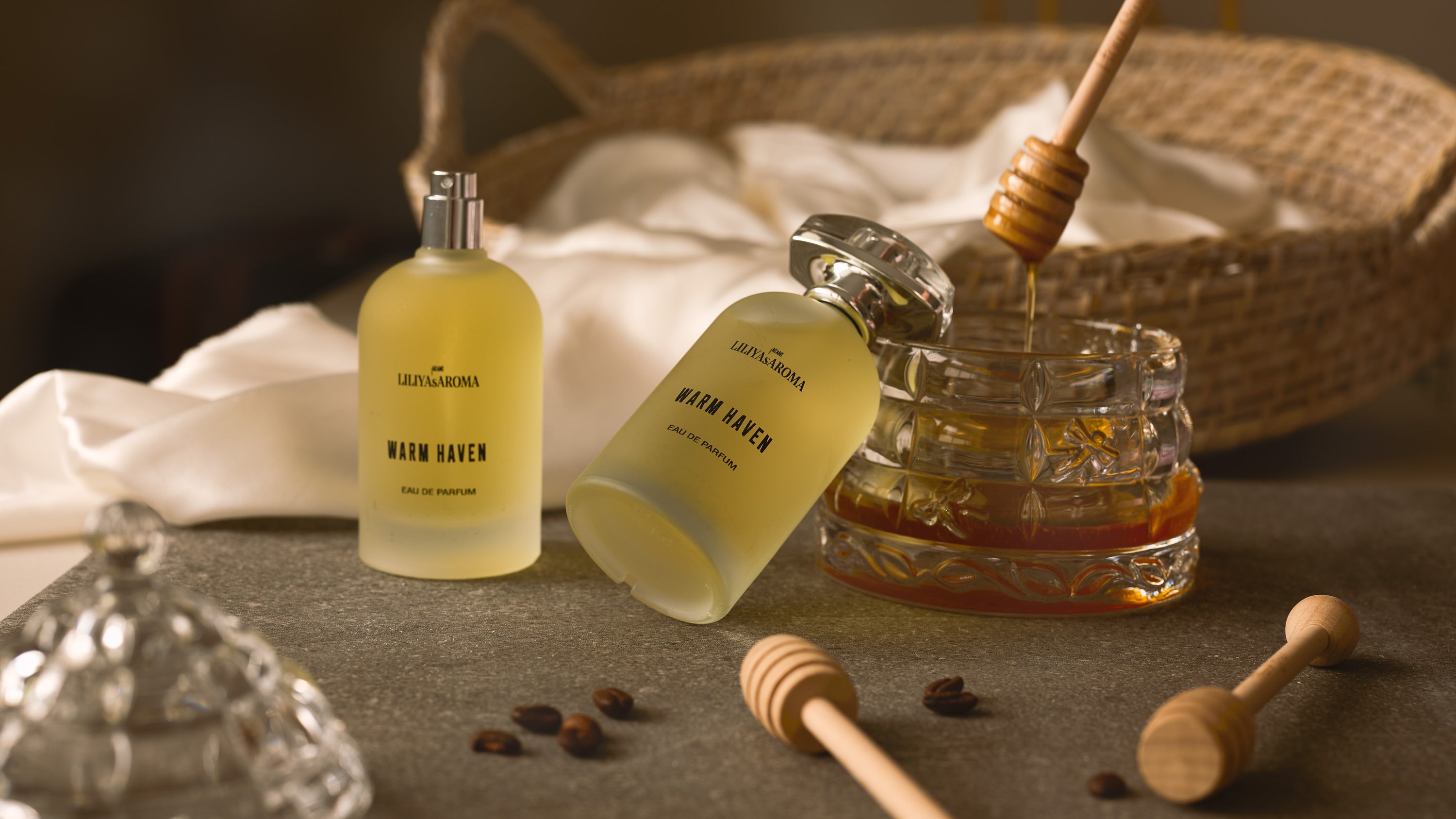 Load video: A promotional video of Warm Haven Eau de Parfum by Liliya’s Aroma. The honey-toned fragrance bottle is showcased in soft, warm lighting with smooth camera movements, highlighting its golden liquid and elegant design. The atmosphere conveys warmth, comfort, and a cozy, inviting scent experience