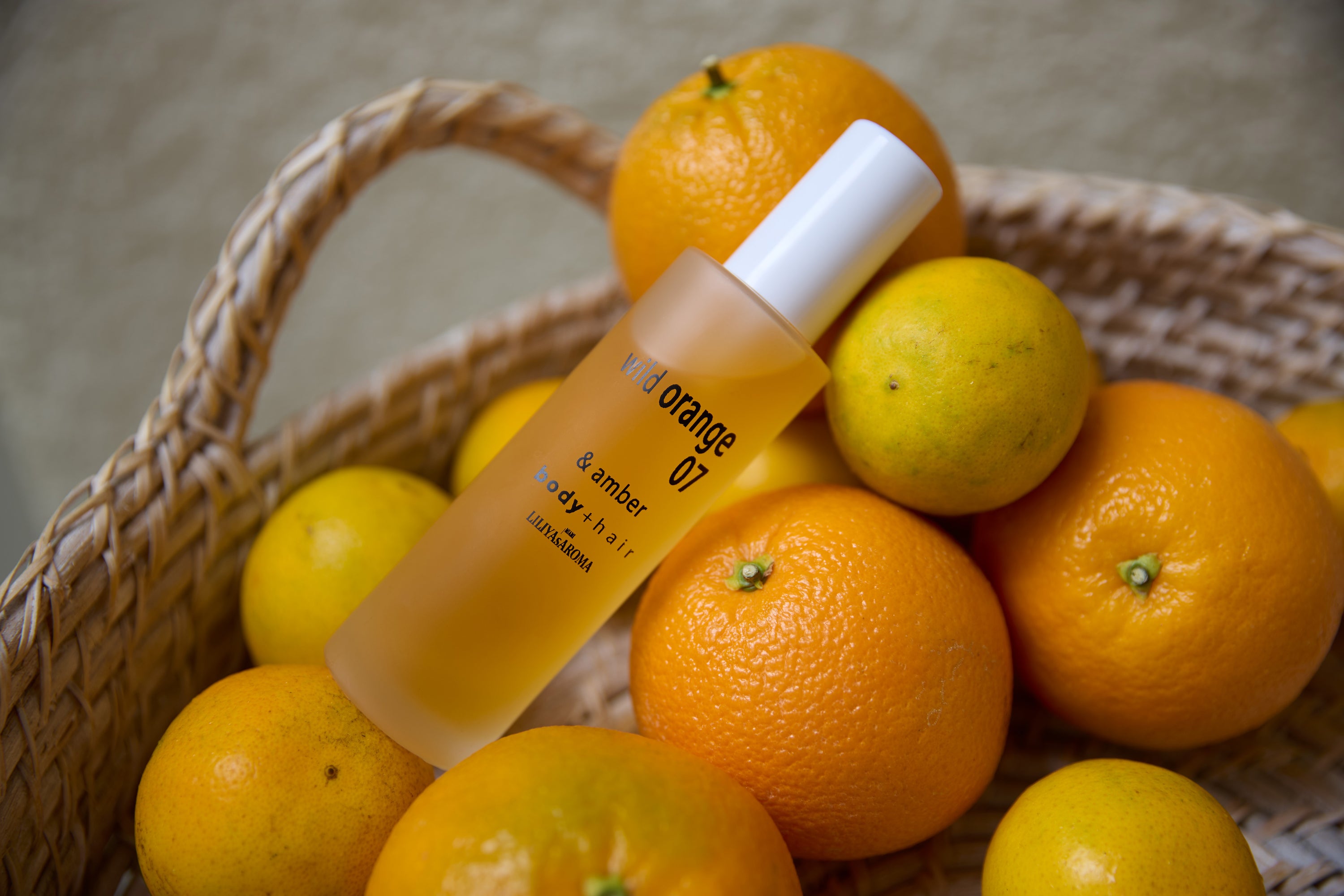 Wild Orange 07 & Amber body mist by Liliya’s Aroma displayed with fresh oranges, featuring bright orange, neroli, and warm amber notes